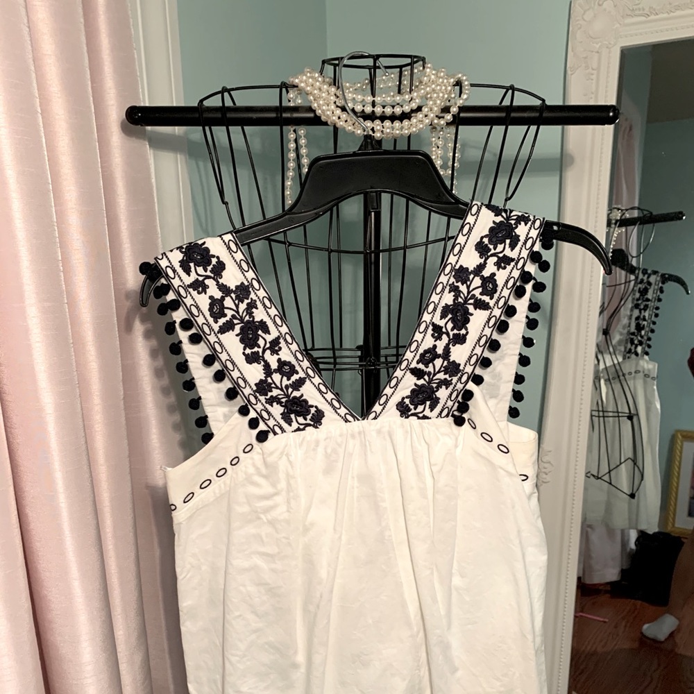 J. Crew white blouse with navy blue embroidery.